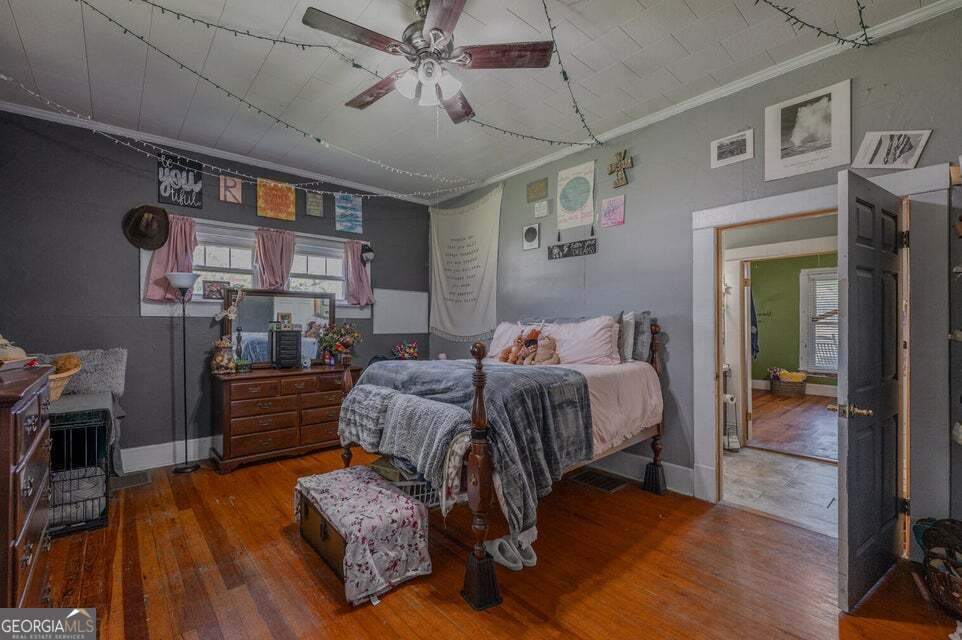 69 Myers Avenue Trion, GA 30753 - Photo 29 of 51 a spacious bedroom with a bed and a wooden floor