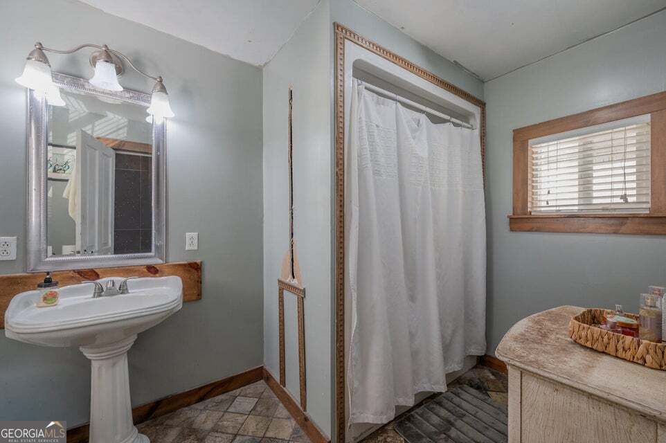 69 Myers Avenue Trion, GA 30753 - Photo 31 of 51 a bathroom with a sink a mirror and a toilet