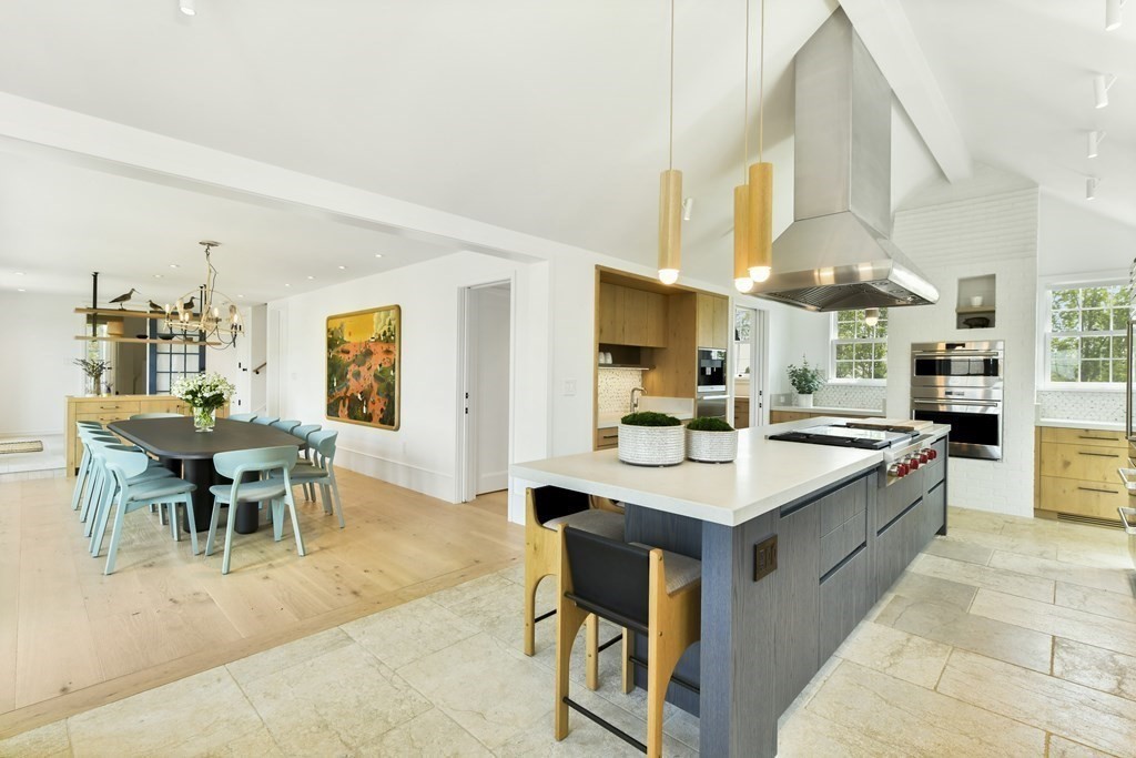 178 Queen Anne Road Chatham, MA 02633 - Photo 15 of 33 a dining hall with stainless steel appliances kitchen island granite countertop a table chairs and a sink