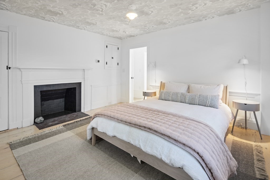 178 Queen Anne Road Chatham, MA 02633 - Photo 21 of 33 a bedroom with a bed and a fireplace