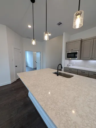 a large kitchen with sink and dishwasher