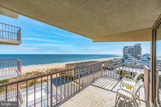 a view of a roof deck with furniture