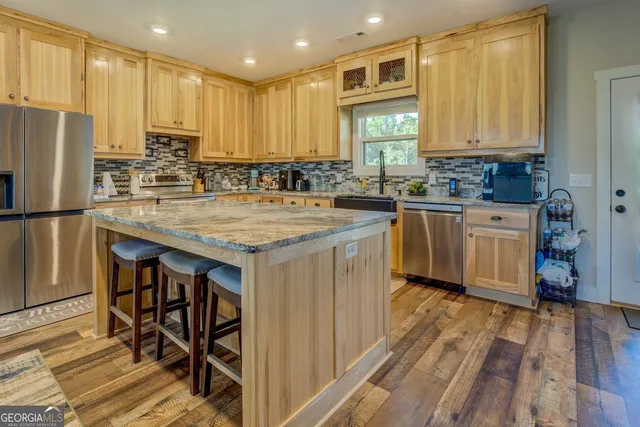 a kitchen with stainless steel appliances granite countertop wooden cabinets a sink and dishwasher
