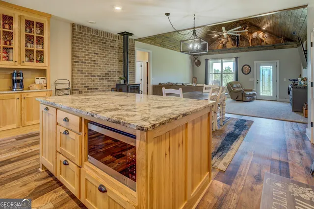 a kitchen with a sink a stove and a wooden cabinets