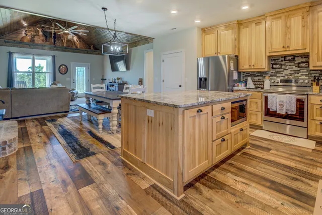 a kitchen with a table and a chandelier