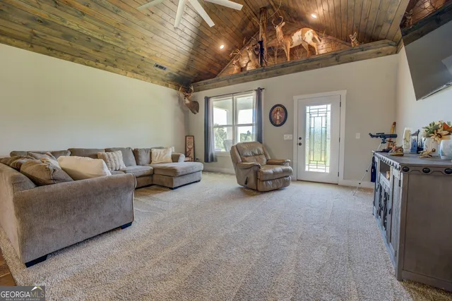 a bed room with a bed and a ceiling fan