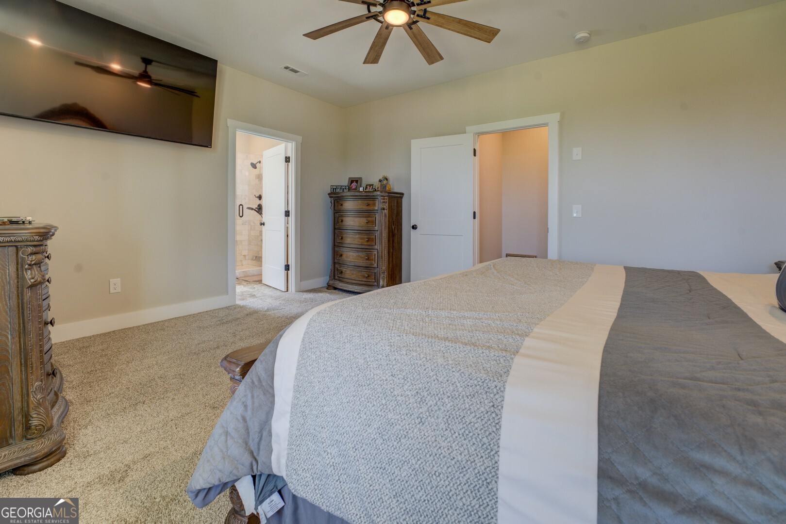 4348 Marshall Stewart Road Crawfordville, GA 30631 - Photo 26 of 80 a bed room with a bed and a ceiling fan