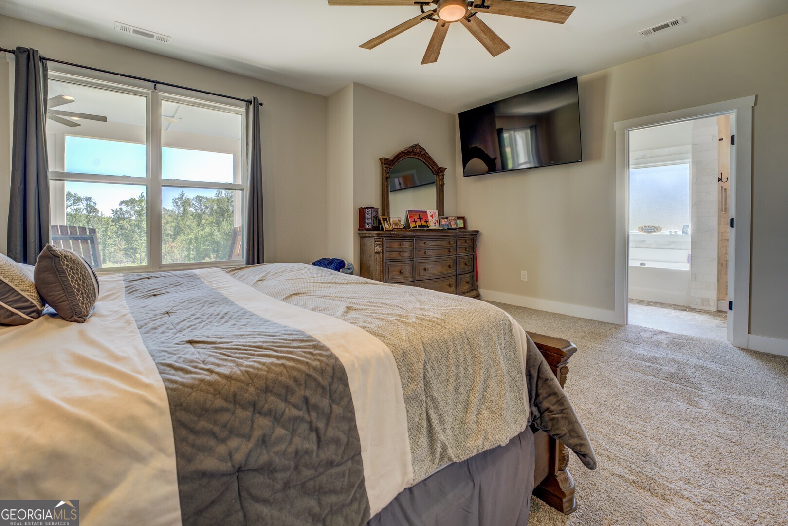 4348 Marshall Stewart Road Crawfordville, GA 30631 - Photo 27 of 80 a bedroom with a bed and a flat tv screen on dresser