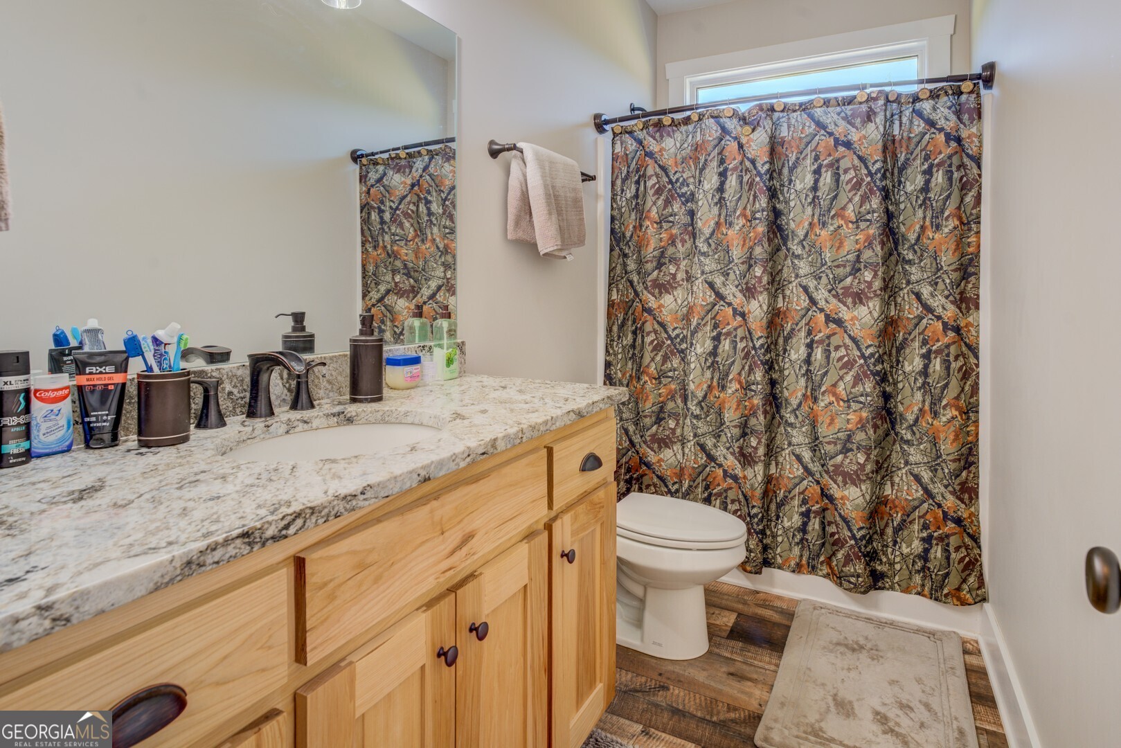 4348 Marshall Stewart Road Crawfordville, GA 30631 - Photo 31 of 80 a bathroom with a granite countertop sink and a toilet