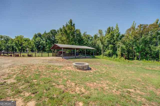a view of a park with trees in the background