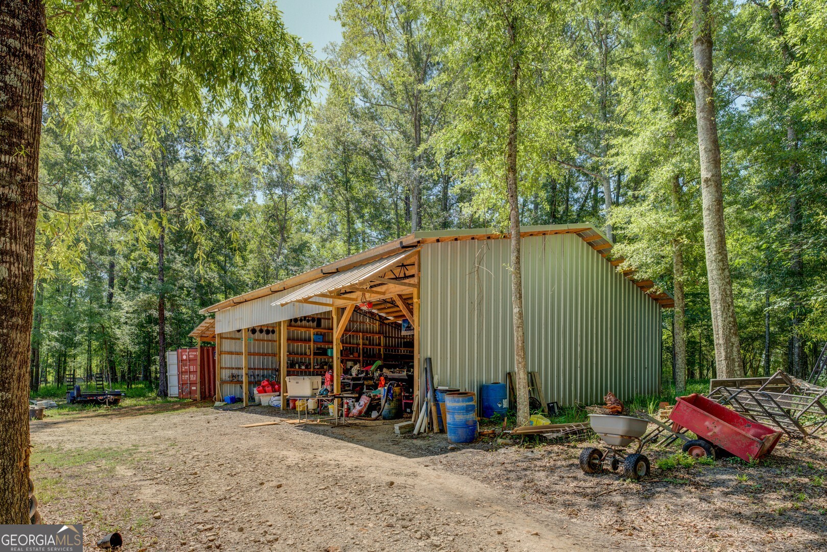 4348 Marshall Stewart Road Crawfordville, GA 30631 - Photo 53 of 80 a view of a house with large trees and sitting area