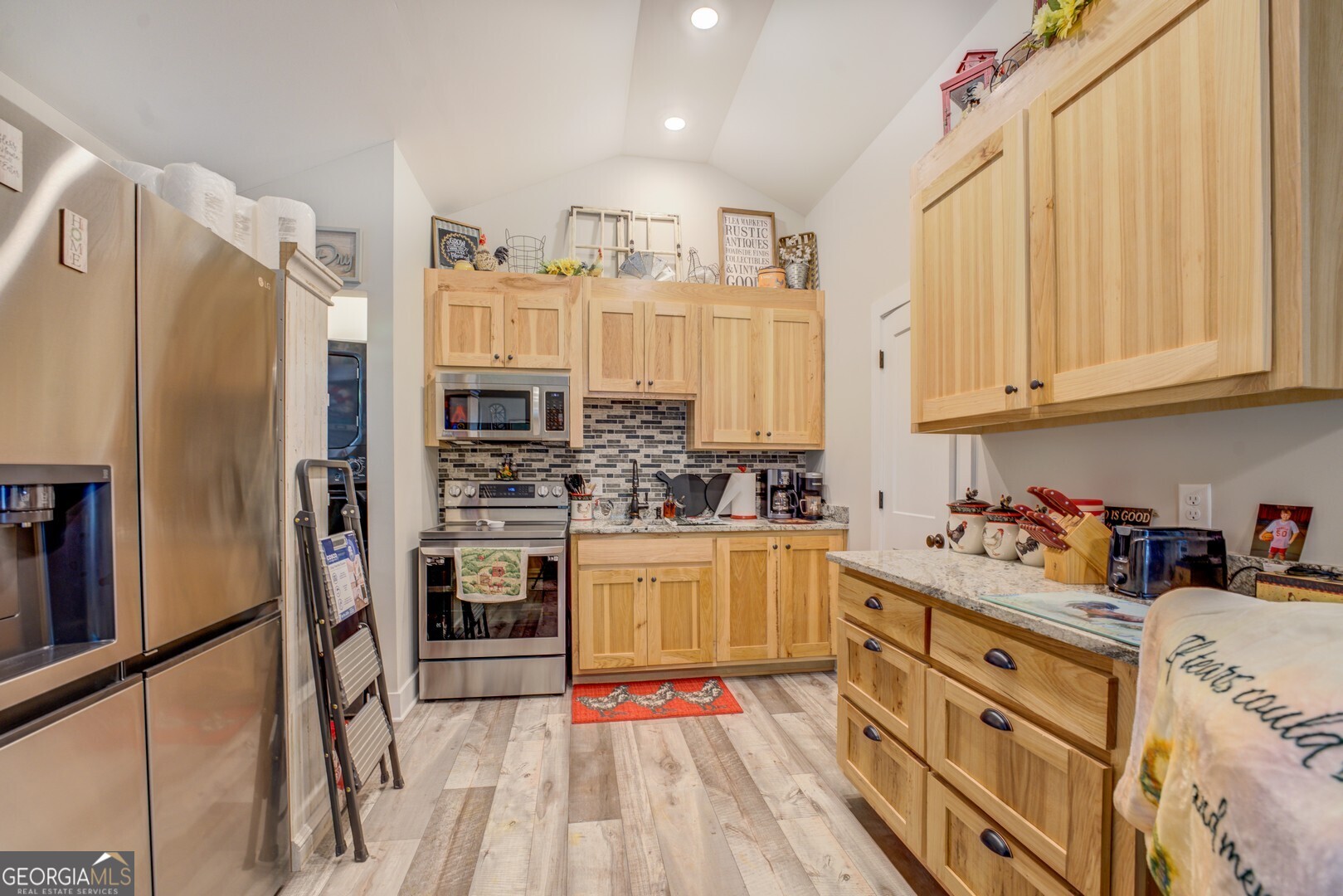 4348 Marshall Stewart Road Crawfordville, GA 30631 - Photo 57 of 80 a kitchen with stainless steel appliances granite countertop a refrigerator sink and cabinets