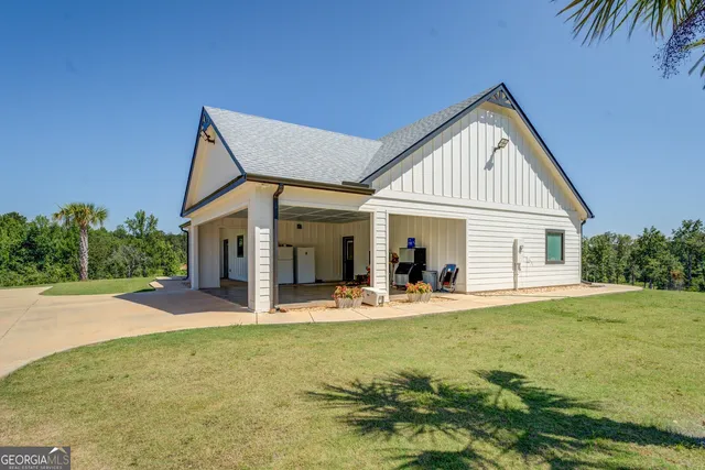 a view of a house with a yard and sitting area
