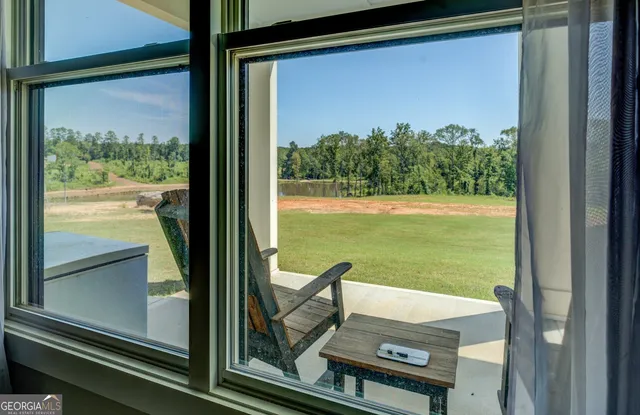 a kitchen with stainless steel appliances granite countertop a table chairs sink refrigerator and cabinets