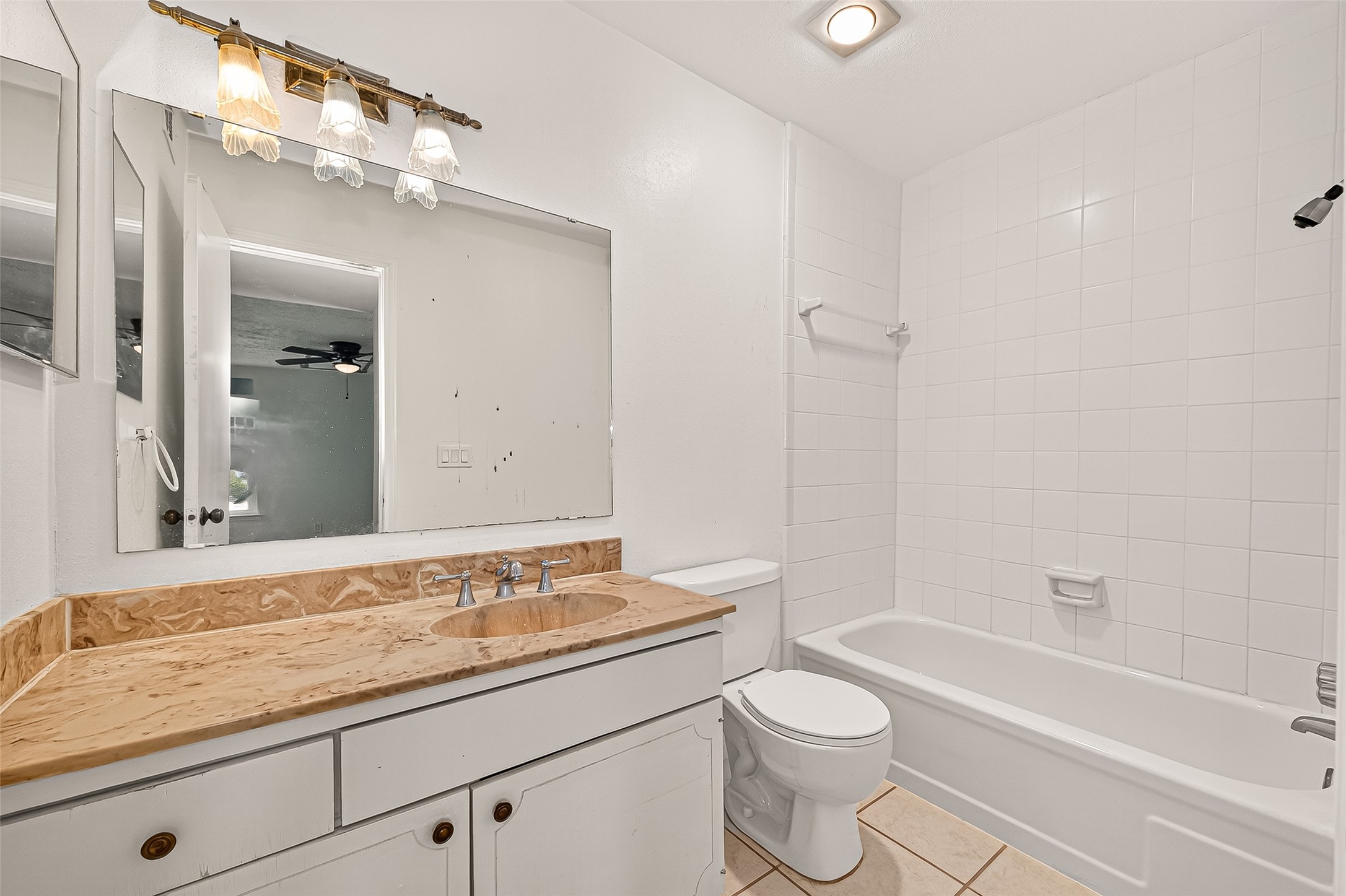 830 Threadneedle Street, Unit 240 Houston, TX 77079 - Photo 16 of 31 a bathroom with a granite countertop sink toilet mirror and bathtub