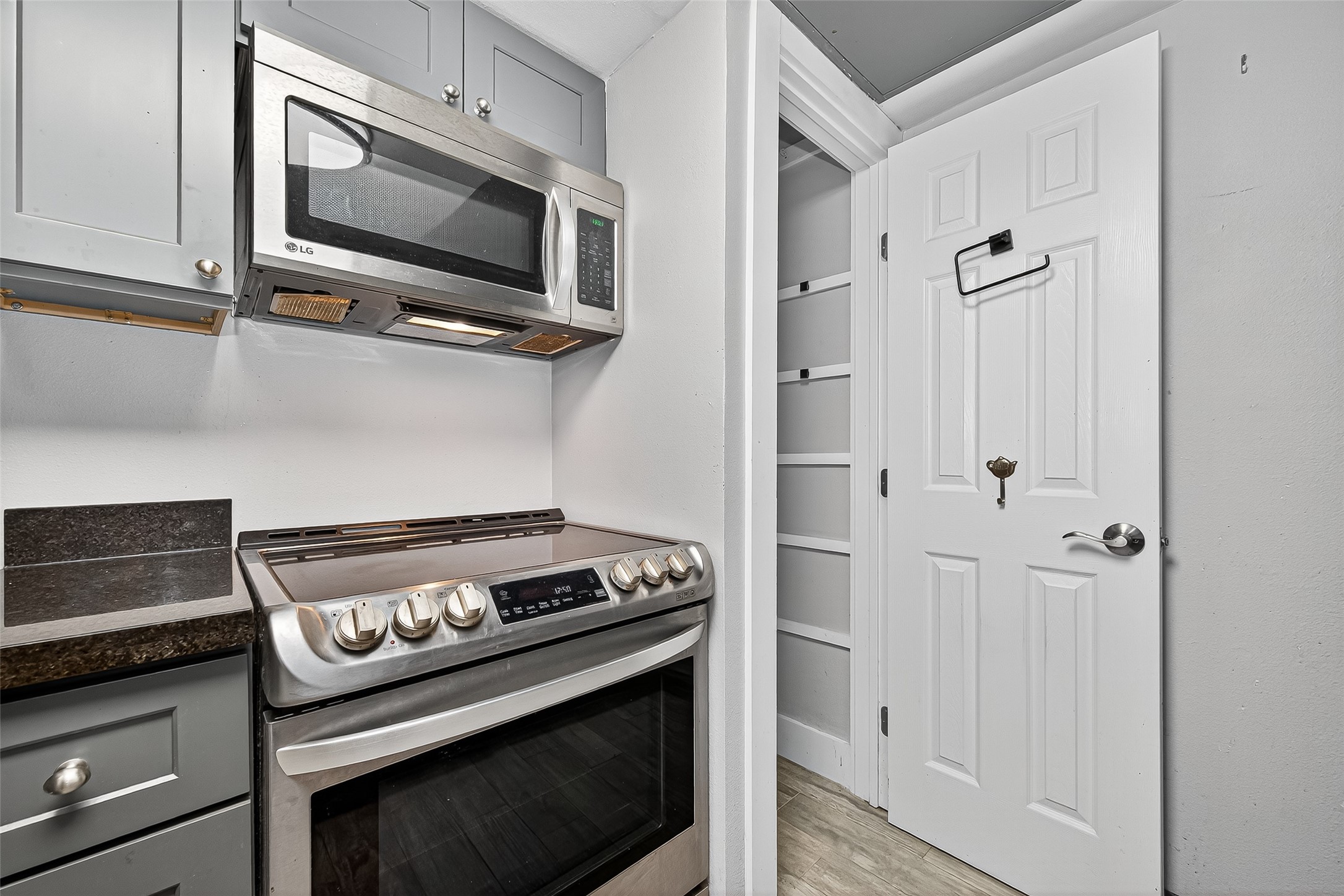 830 Threadneedle Street, Unit 240 Houston, TX 77079 - Photo 4 of 31 a kitchen with white cabinets and stainless steel appliances