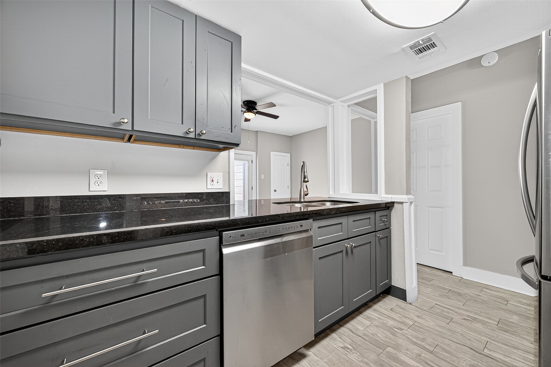 830 Threadneedle Street, Unit 240 Houston, TX 77079 - Photo 5 of 31 a kitchen with granite countertop white cabinets and white appliances