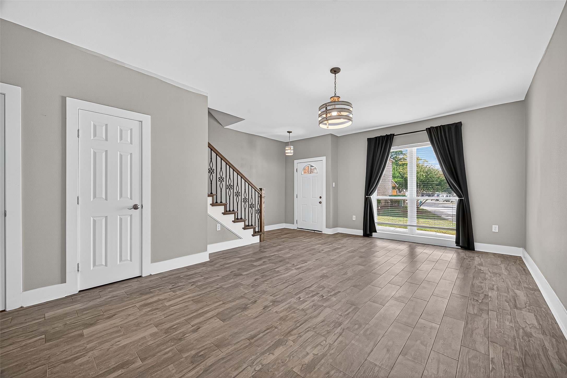 830 Threadneedle Street, Unit 240 Houston, TX 77079 - Photo 6 of 31 a view of an empty room with a window and wooden floor
