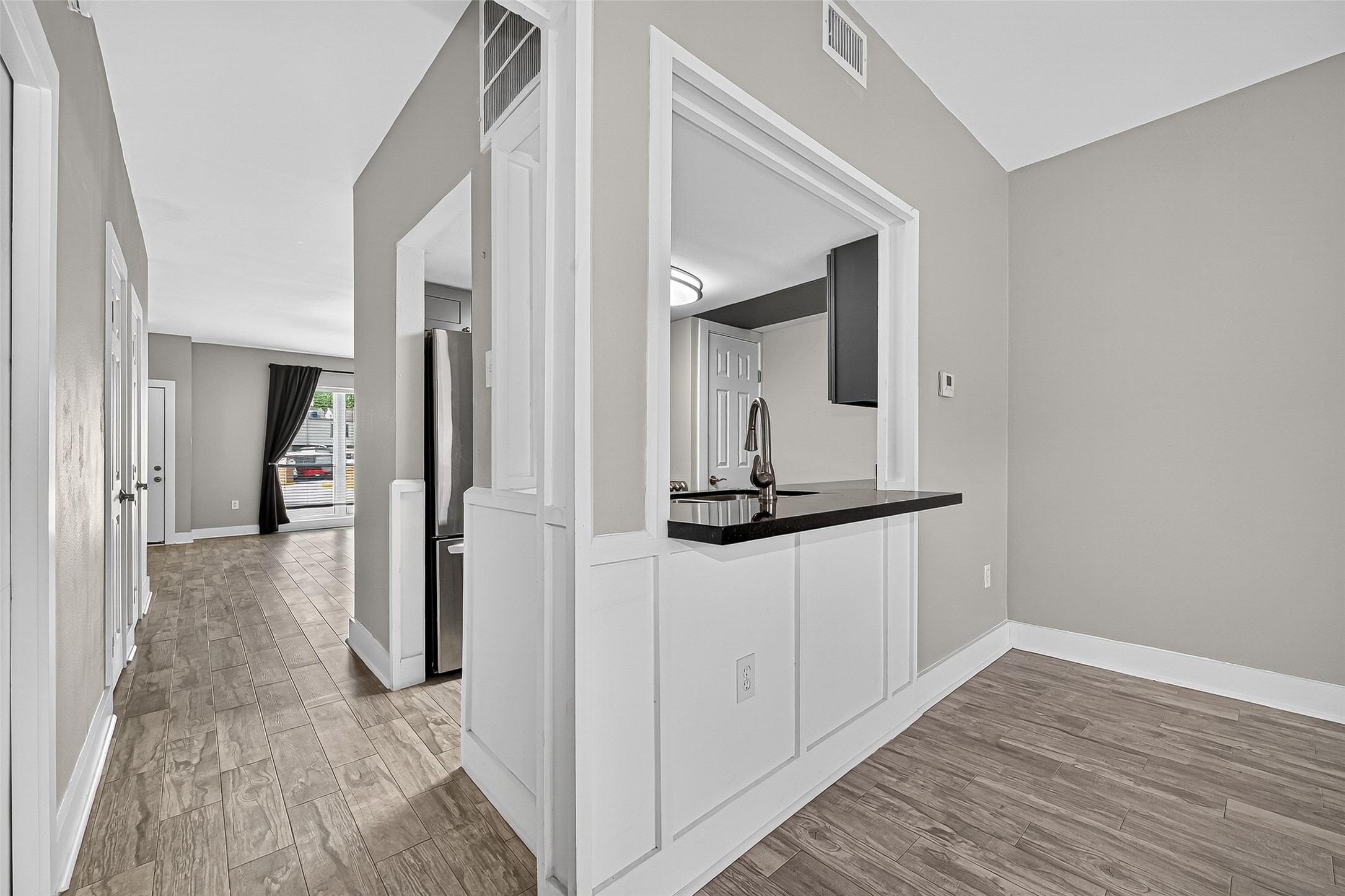 830 Threadneedle Street, Unit 240 Houston, TX 77079 - Photo 9 of 31 a view of a hallway with wooden floor and staircase