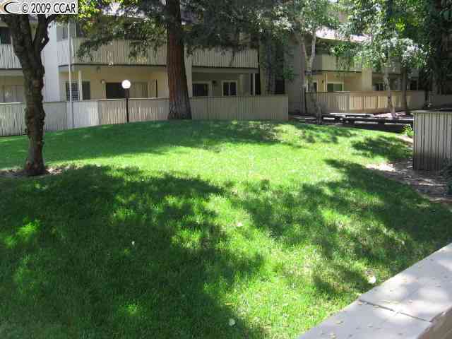 2712 Oak Road, Unit 62 Walnut Creek, CA 94597 - Photo 1 of 1 a view of a backyard with table and chairs and garden