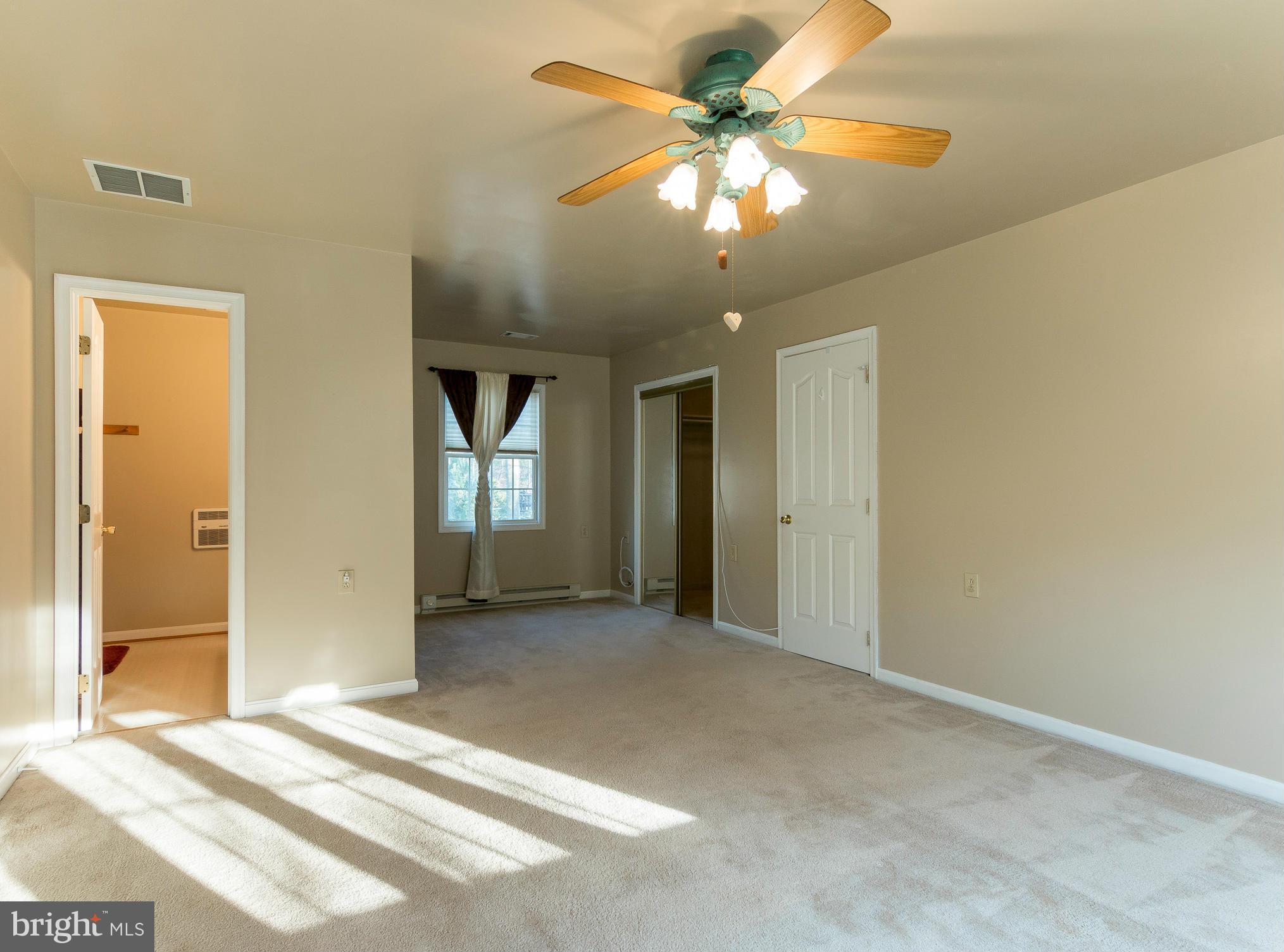 8807 Indian Springs Road Frederick, MD 21702 - Photo 19 of 27 a view of a hallway with a chandelier