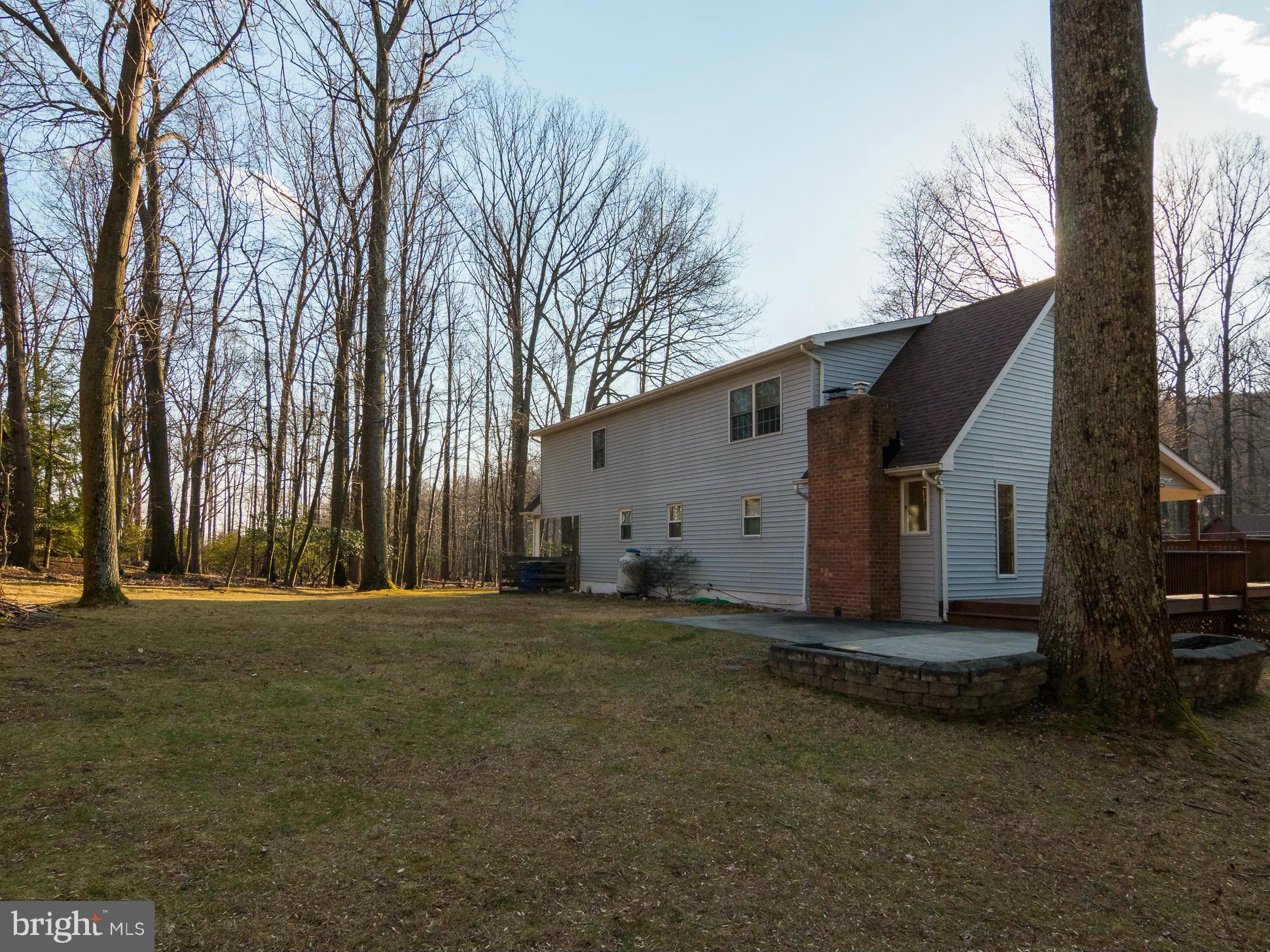 8807 Indian Springs Road Frederick, MD 21702 - Photo 5 of 27 a view of a house with a large tree and wooden fence