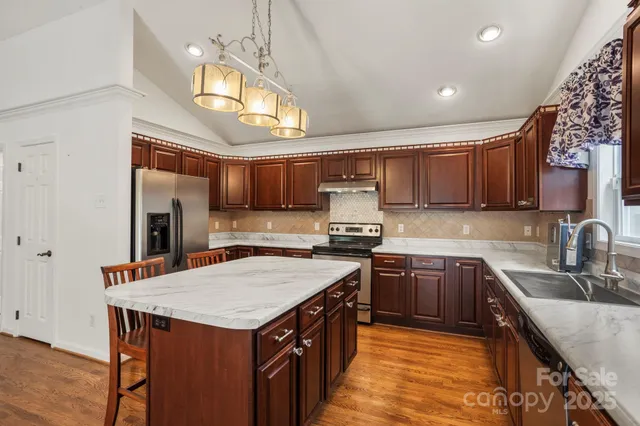 a kitchen with a stove sink and cabinets