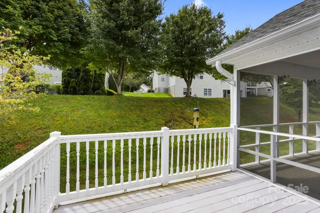 a balcony with wooden floor and fence