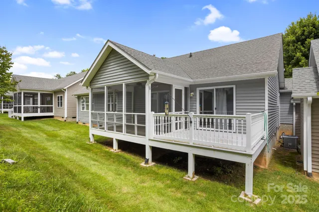 a view of a house with a deck and a yard