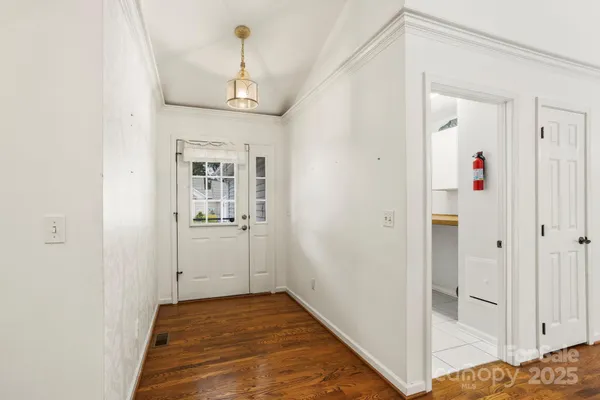 a view of a hallway view with wooden floor and staircase