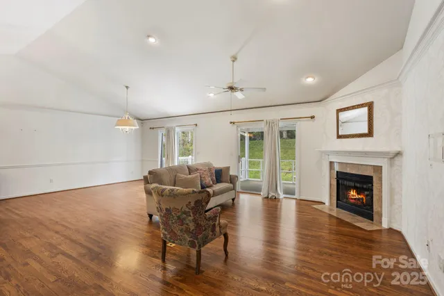 a living room with furniture fireplace and wooden floor