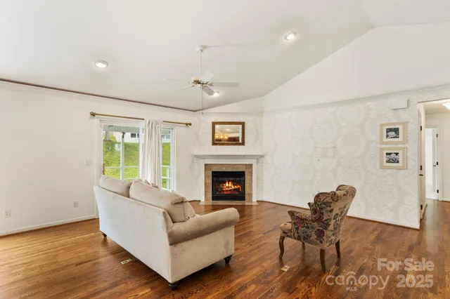 a living room with furniture fireplace and window