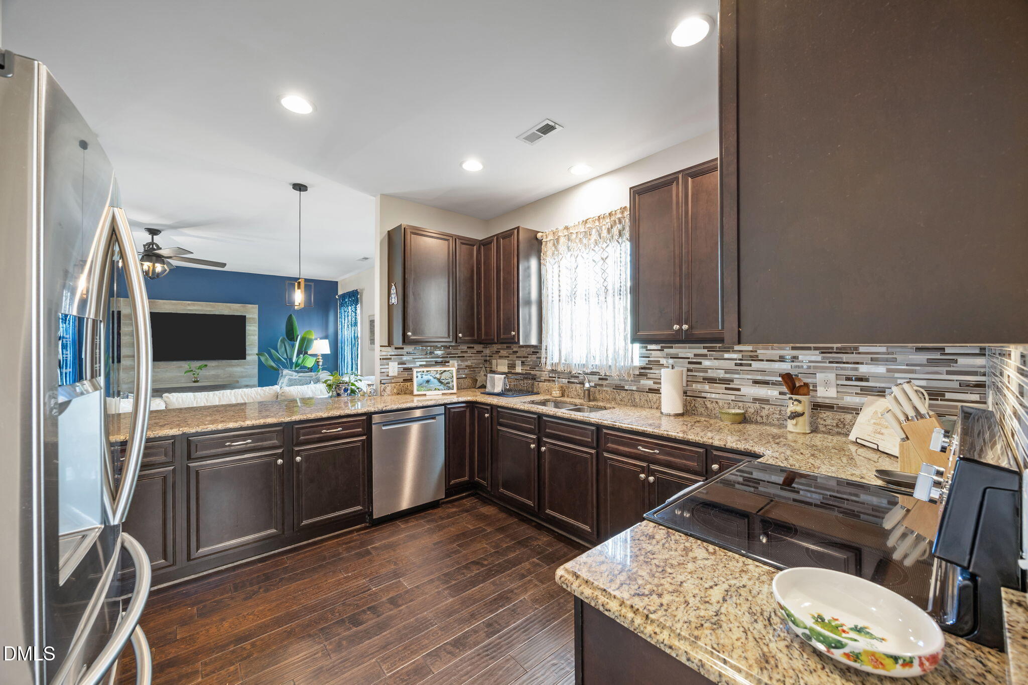 2329 Longshadow Drive Graham, NC 27253 - Photo 17 of 52 a kitchen with stainless steel appliances granite countertop a sink stove and refrigerator