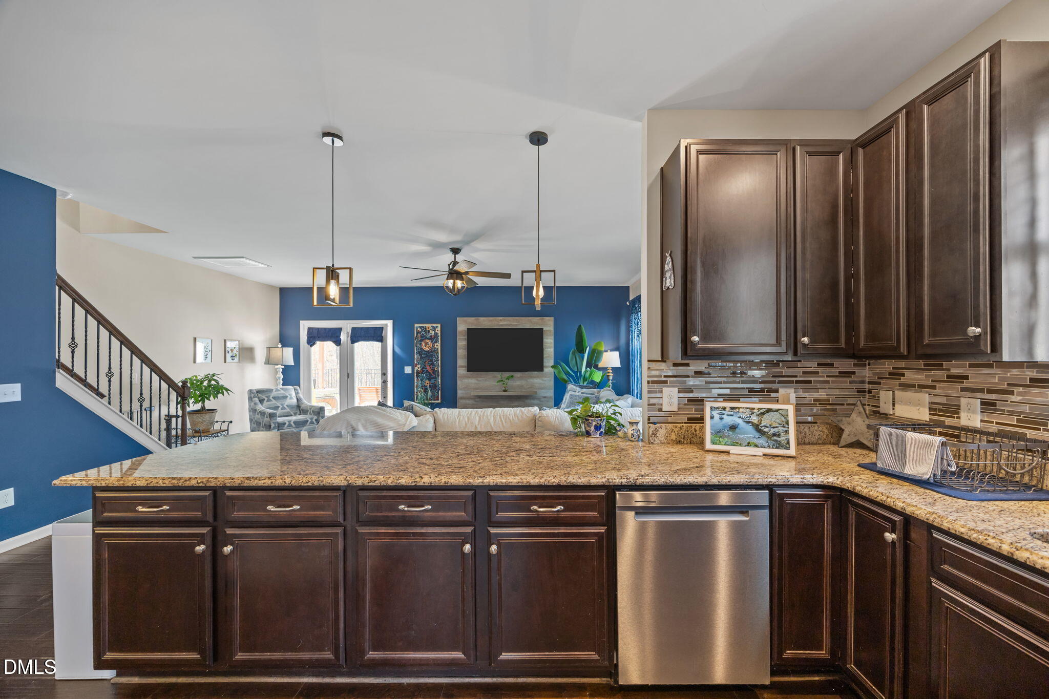 2329 Longshadow Drive Graham, NC 27253 - Photo 19 of 52 a kitchen with kitchen island granite countertop a sink stainless steel appliances and cabinets