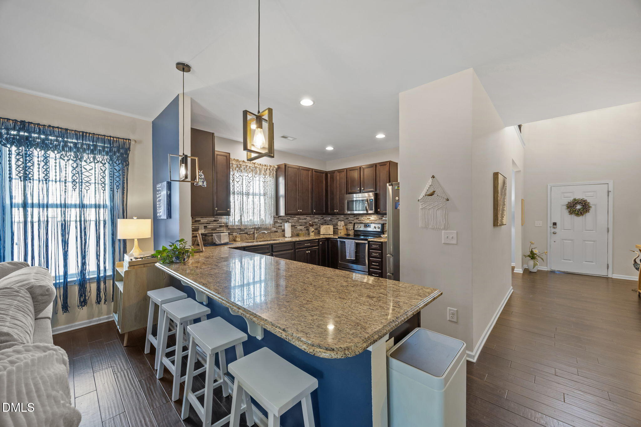 2329 Longshadow Drive Graham, NC 27253 - Photo 21 of 52 a kitchen with stainless steel appliances granite countertop kitchen island a table and chairs