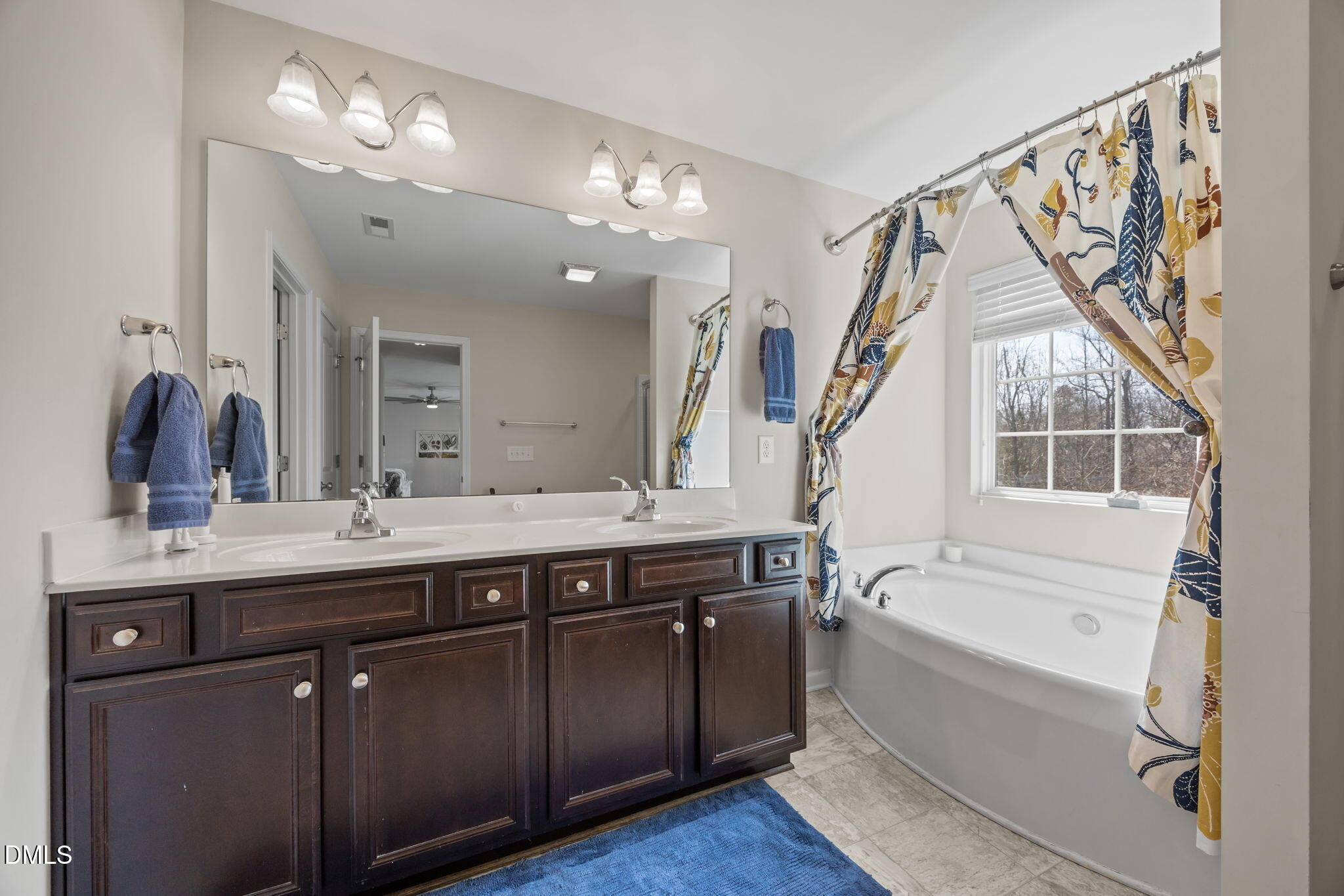 2329 Longshadow Drive Graham, NC 27253 - Photo 35 of 52 a spacious bathroom with a double vanity sink a mirror and a bathtub