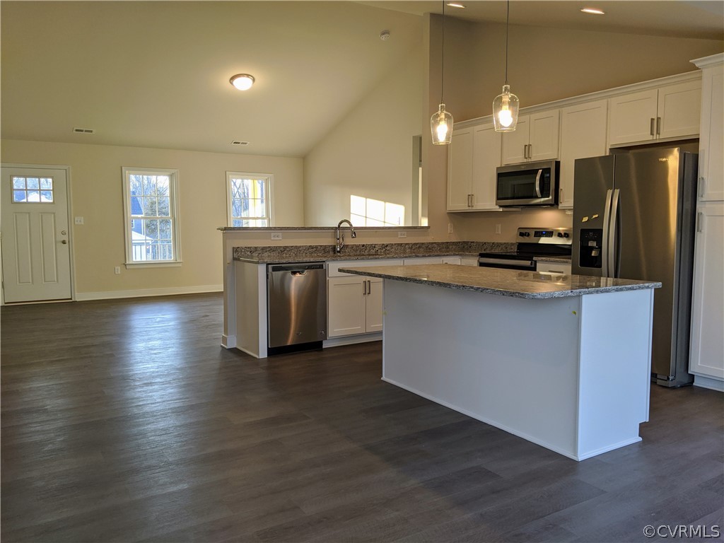 12006 Corte Castle Road Chesterfield, VA 23838 - Photo 3 of 41 a kitchen with stainless steel appliances granite countertop a stove a sink dishwasher a refrigerator and white cabinets with wooden floor