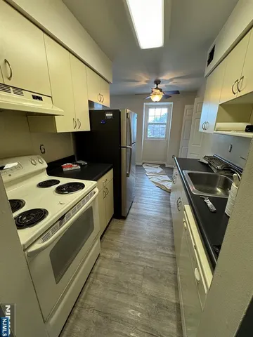 a kitchen with a stove and a refrigerator
