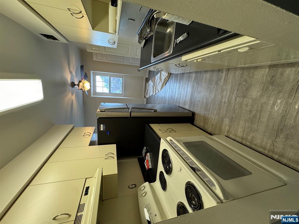 360 Knickerbocker Road, Unit 24 Dumont, NJ 07628 - Photo 2 of 8 a kitchen with a stove and a refrigerator