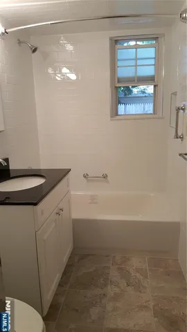 a view of car parked on the side of a street