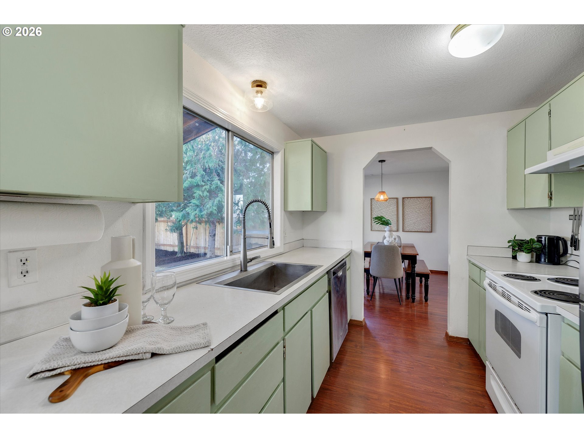16082 Southwest 93rd Avenue Tigard, OR 97224 - Photo 12 of 35 a kitchen with a sink stove and cabinets