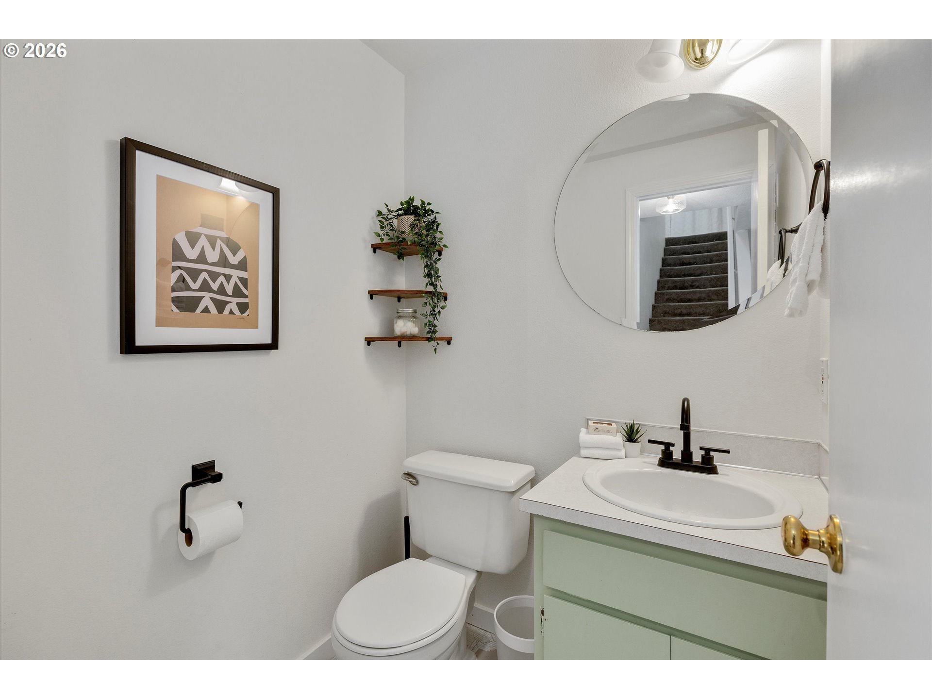 16082 Southwest 93rd Avenue Tigard, OR 97224 - Photo 19 of 35 a bathroom with a toilet a sink and mirror