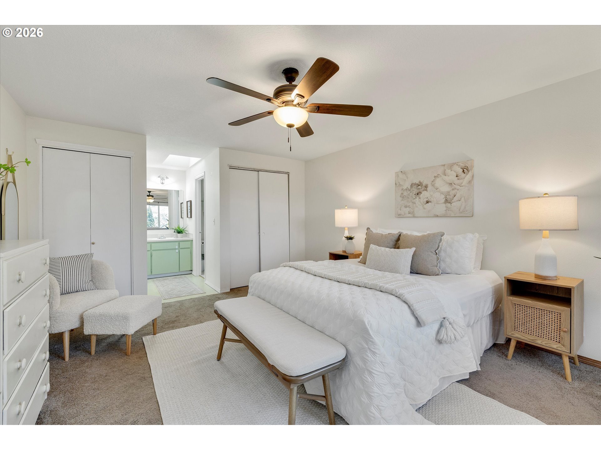 16082 Southwest 93rd Avenue Tigard, OR 97224 - Photo 20 of 35 a spacious bedroom with a bed and a chandelier