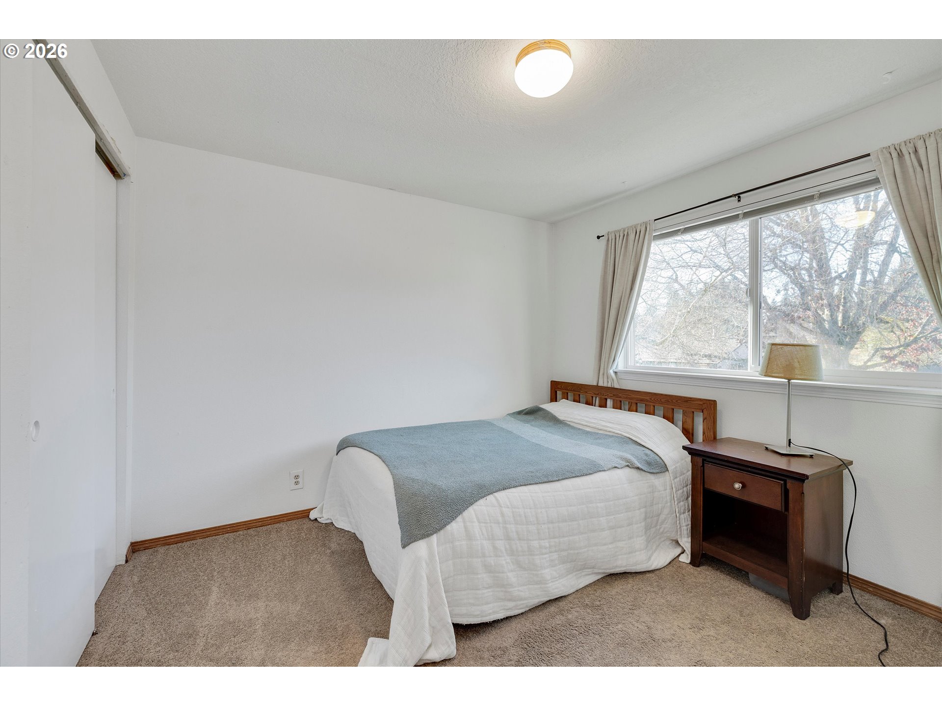 16082 Southwest 93rd Avenue Tigard, OR 97224 - Photo 26 of 35 a bedroom with a bed and a large window