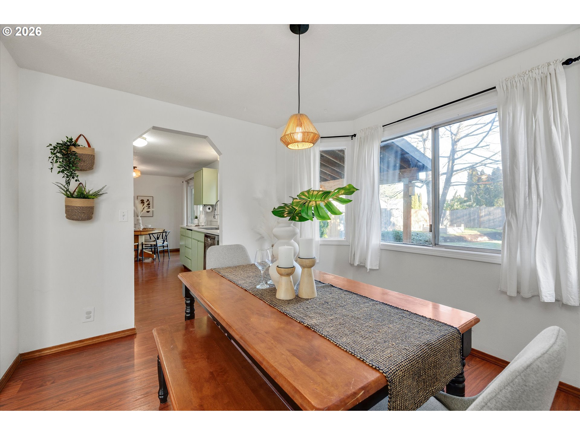 16082 Southwest 93rd Avenue Tigard, OR 97224 - Photo 10 of 35 a dining room with furniture a chandelier and wooden floor