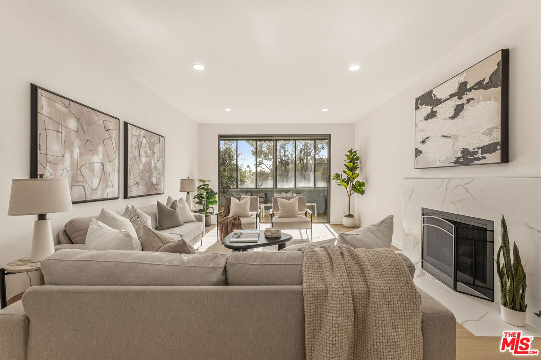 311 Bora Bora Way, Unit 3207 Marina del Rey, CA 90292 - Photo 3 of 54 a living room with furniture and a fireplace