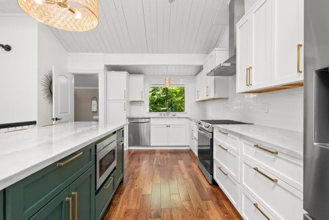 a kitchen with granite countertop white cabinets and white appliances