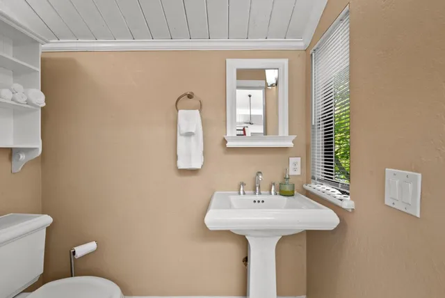 a bathroom with a sink a mirror and a toilet