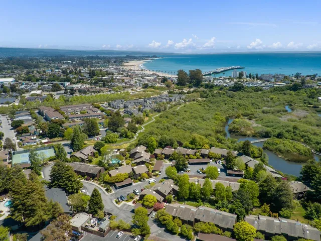 an aerial view of residential building and ocean