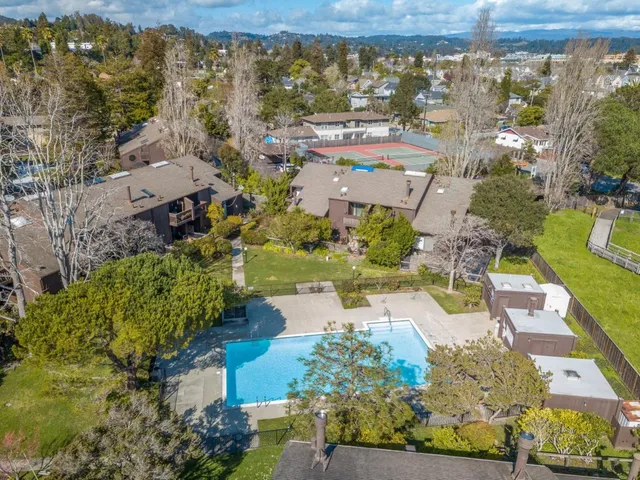 an aerial view of a house with a yard